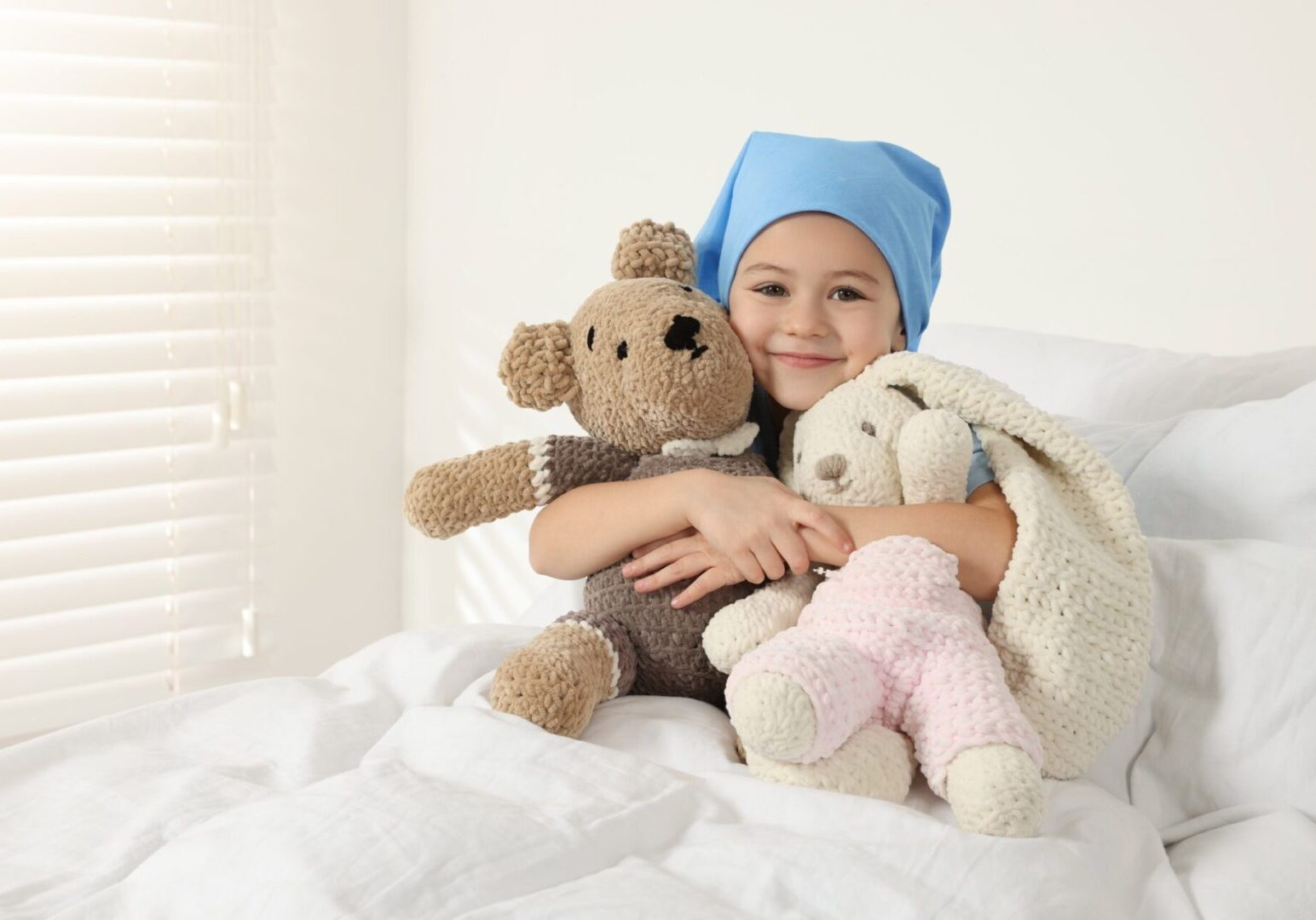Childhood,Cancer.,Girl,Hugging,Toy,Bunny,And,Bear,In,Hospital